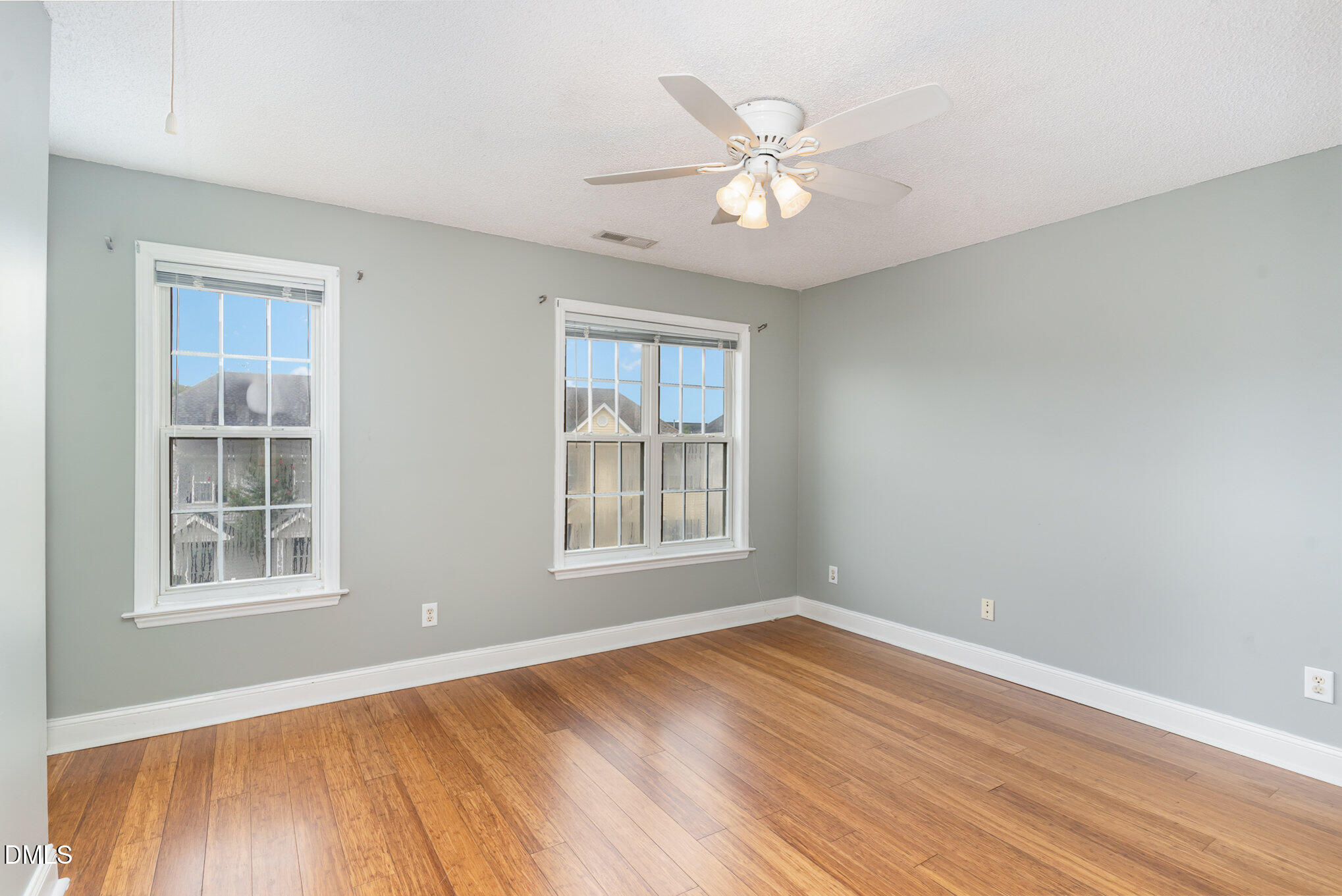 2215 Turtle Point Drive Raleigh, NC 27604 - Photo 4 of 25 a view of an empty room with wooden floor and a window
