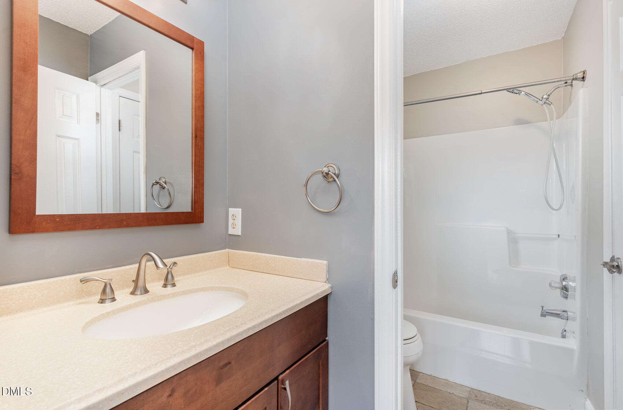 2215 Turtle Point Drive Raleigh, NC 27604 - Photo 5 of 25 a bathroom with a granite countertop sink mirror toilet and bathtub