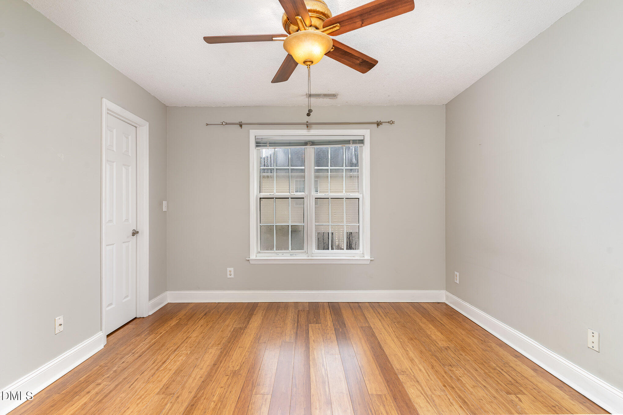 2215 Turtle Point Drive Raleigh, NC 27604 - Photo 6 of 25 a view of an empty room with window and wooden floor