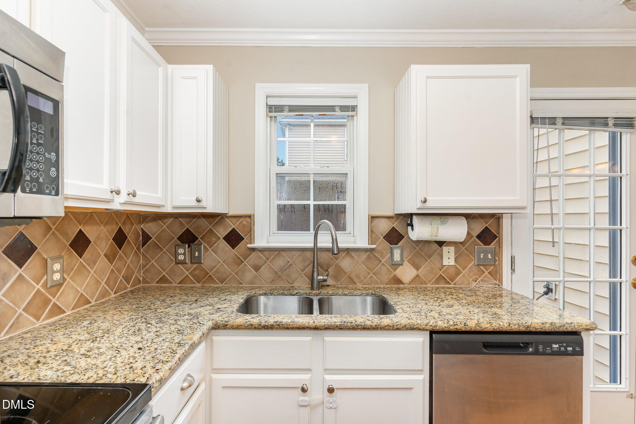 2215 Turtle Point Drive Raleigh, NC 27604 - Photo 9 of 25 a kitchen with granite countertop a sink a window and cabinets
