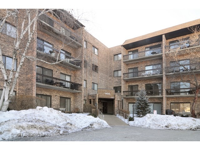 1400 North Elmhurst Road, Unit 313 Mount Prospect, IL 60056 - Photo 1 of 10 a view of a building with a outdoor space