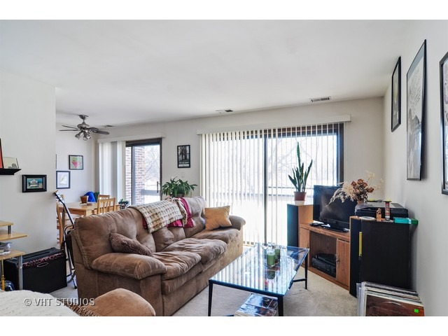 1400 North Elmhurst Road, Unit 313 Mount Prospect, IL 60056 - Photo 2 of 10 a living room with furniture and a large window