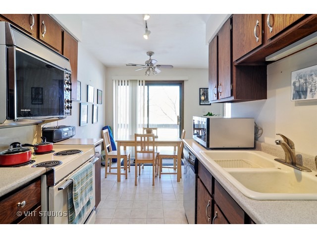 1400 North Elmhurst Road, Unit 313 Mount Prospect, IL 60056 - Photo 5 of 10 a kitchen with a sink stove and cabinets