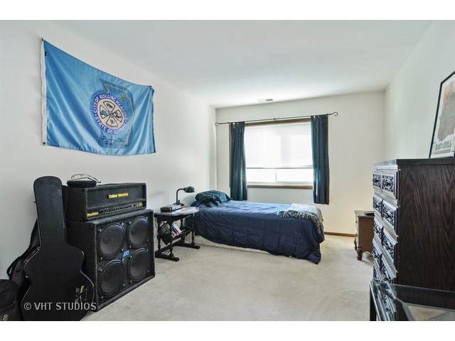 1400 North Elmhurst Road, Unit 313 Mount Prospect, IL 60056 - Photo 7 of 10 a bedroom with a bed and a desk