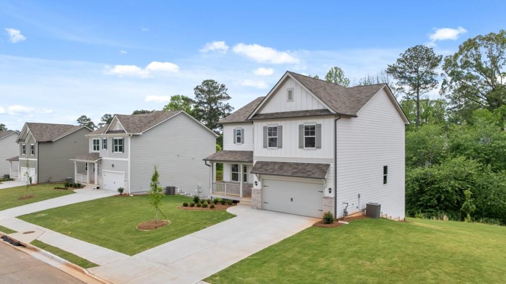 174 Thompson Ridge Lane Dallas, GA 30132 - Photo 2 of 35 a front view of a house with a garden and yard