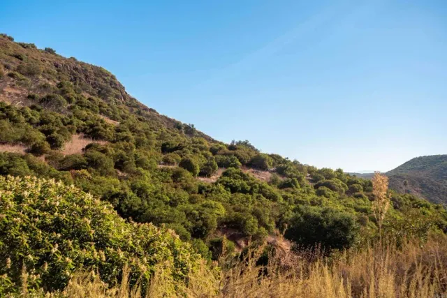 a view of a large mountain with mountains in the background