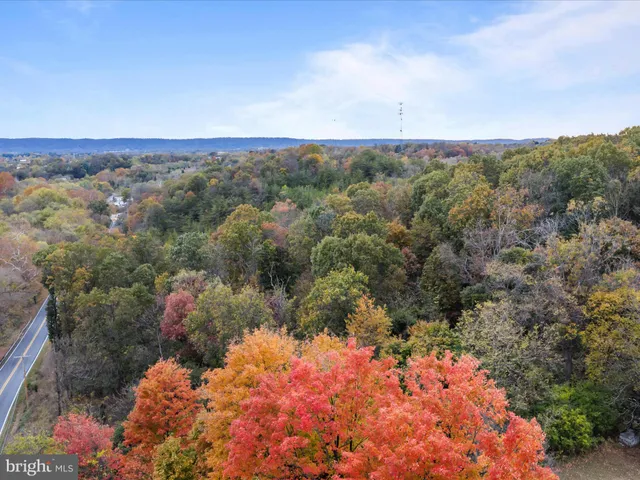 an aerial view of house with yard and mountain view in back