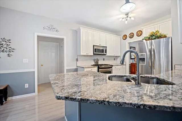 a kitchen with a sink stove and cabinets