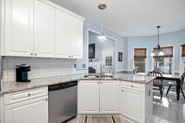 a kitchen with sink stove and cabinets