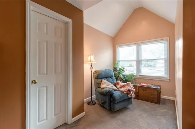 a spacious bedroom with a bed and a chandelier