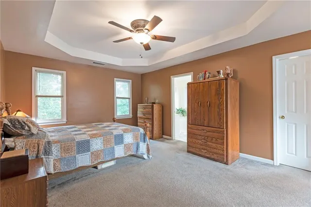 a bathroom with a tub a sink and mirror