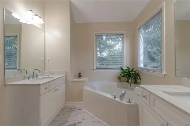 a bathroom with a double vanity sink and a mirror