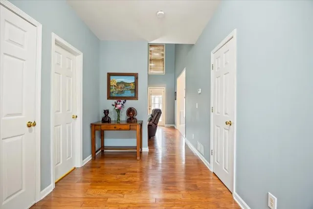 a view of a dining room with furniture a chandelier and wooden floor
