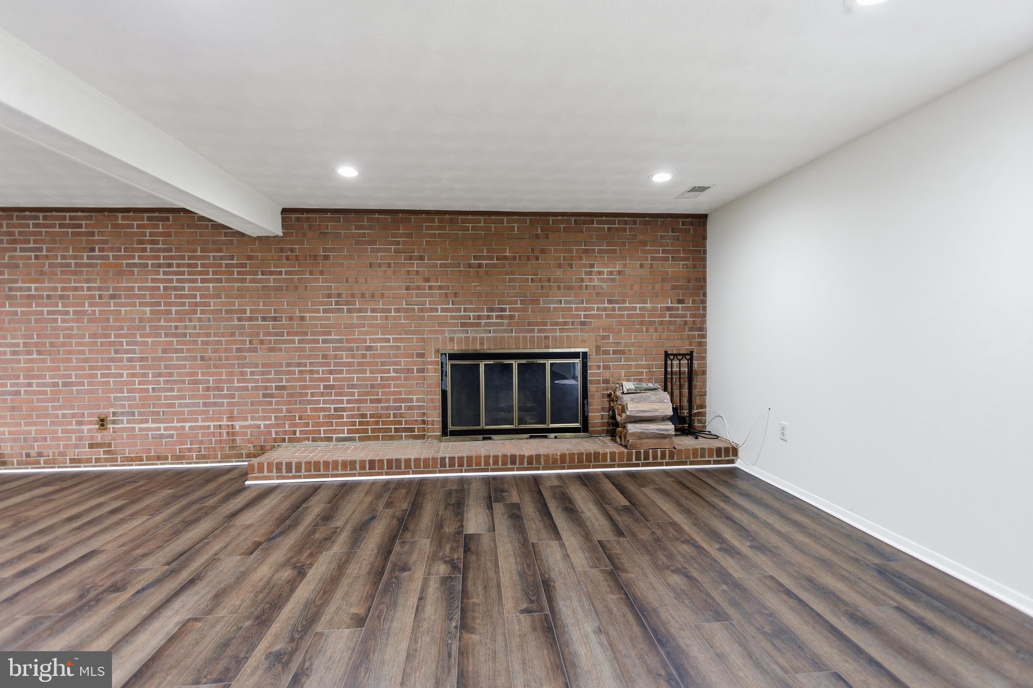 14717 Flintstone Lane Silver Spring, MD 20905 - Photo 2 of 32 a view of empty room with wooden floor and a fireplace