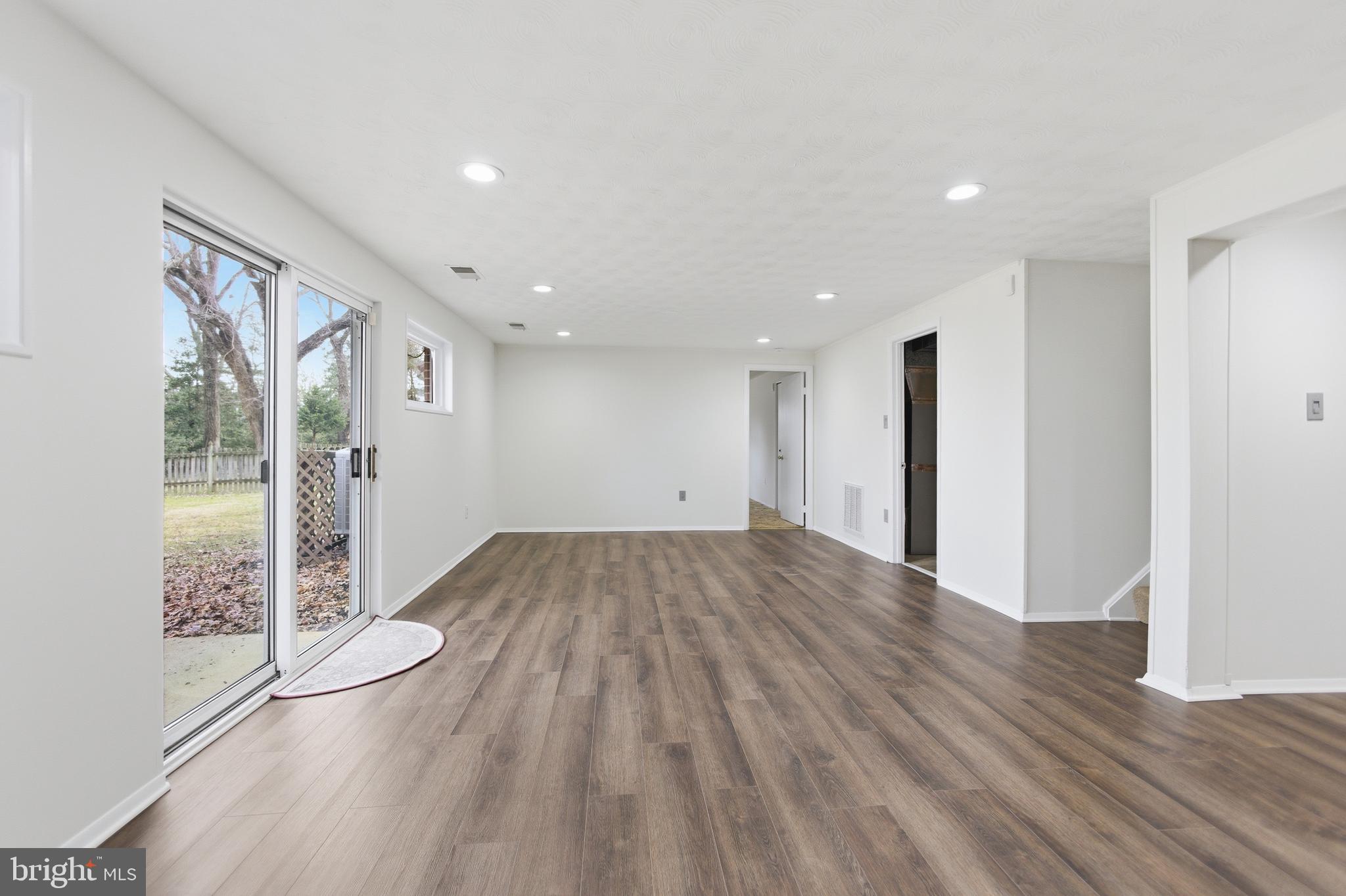 14717 Flintstone Lane Silver Spring, MD 20905 - Photo 6 of 32 a view of empty room with wooden floor and fan