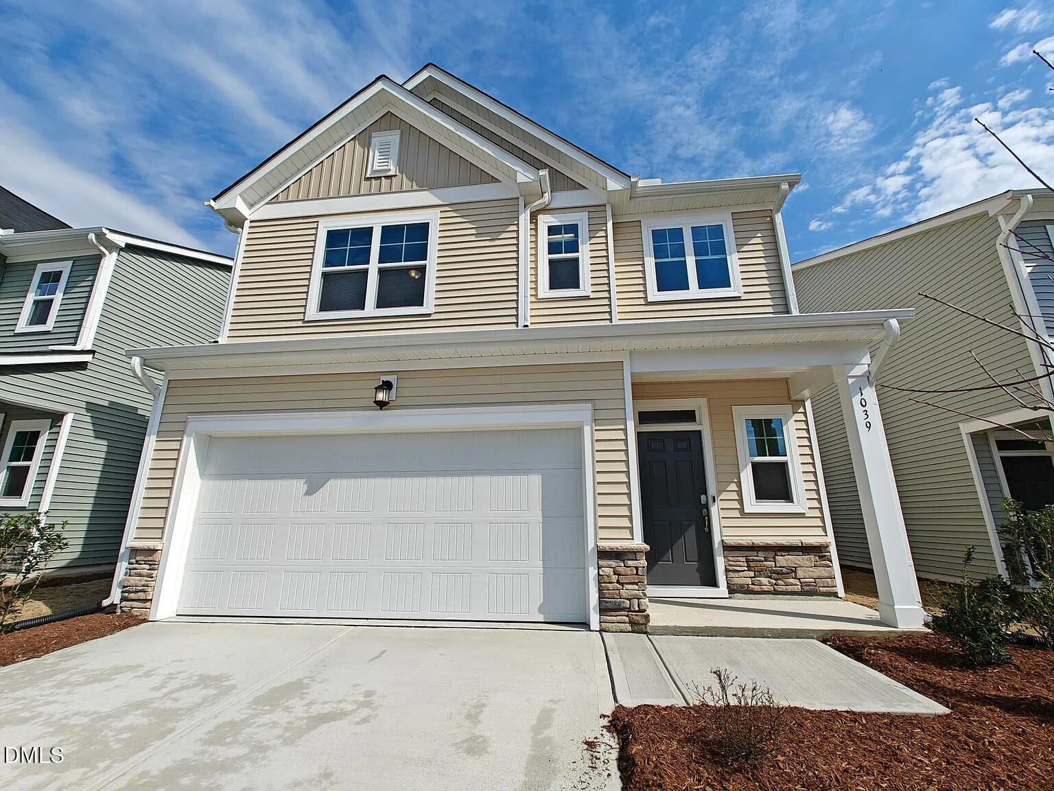 a front view of a house with garage
