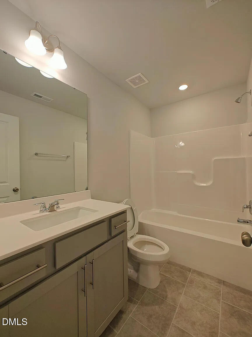 1039 Red Wing Drive Durham, NC 27703 - Photo 12 of 40 a bathroom with a sink a toilet and shower