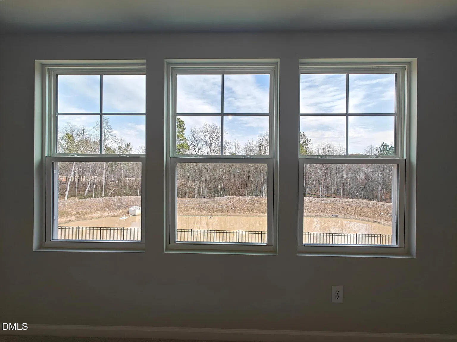1039 Red Wing Drive Durham, NC 27703 - Photo 19 of 40 a view of an empty room with wooden floor and windows