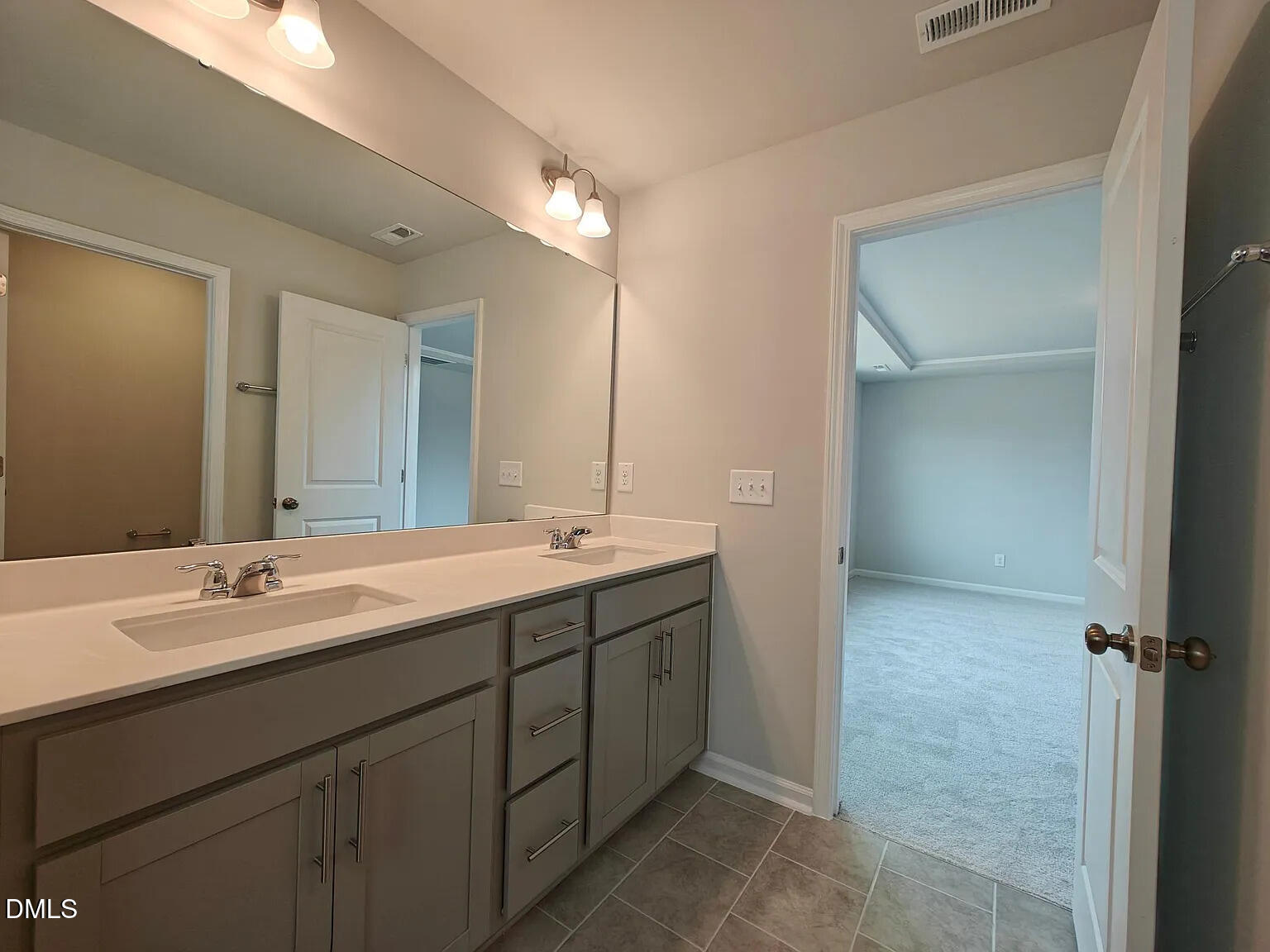 1039 Red Wing Drive Durham, NC 27703 - Photo 21 of 40 a bathroom with a double vanity sink and mirror
