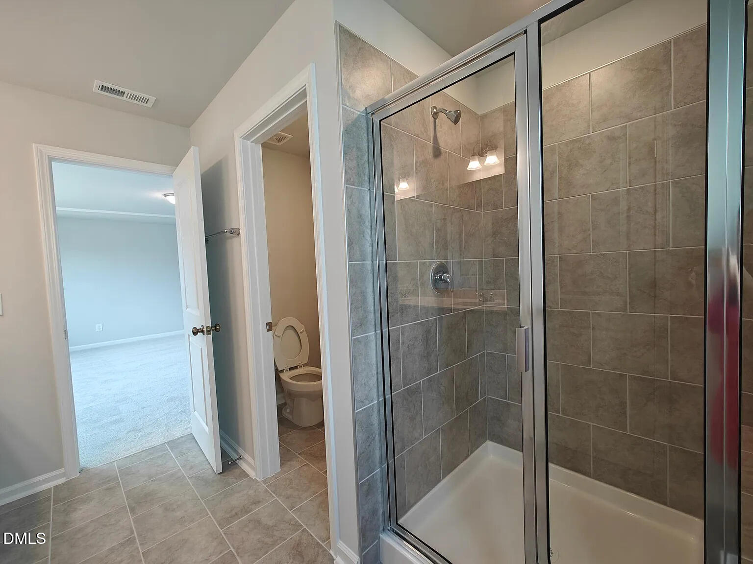 1039 Red Wing Drive Durham, NC 27703 - Photo 22 of 40 a bathroom with a glass shower door and a bathroom sink