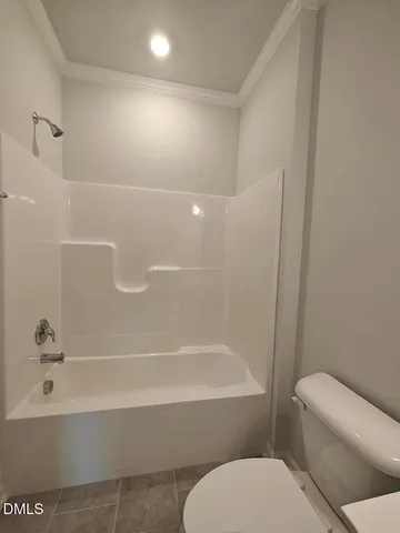 a bathroom with a toilet and a tub