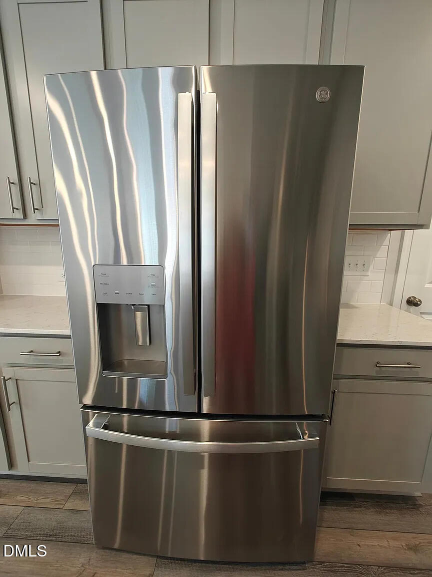 1039 Red Wing Drive Durham, NC 27703 - Photo 9 of 40 a view of a refrigerator in kitchen and an empty room