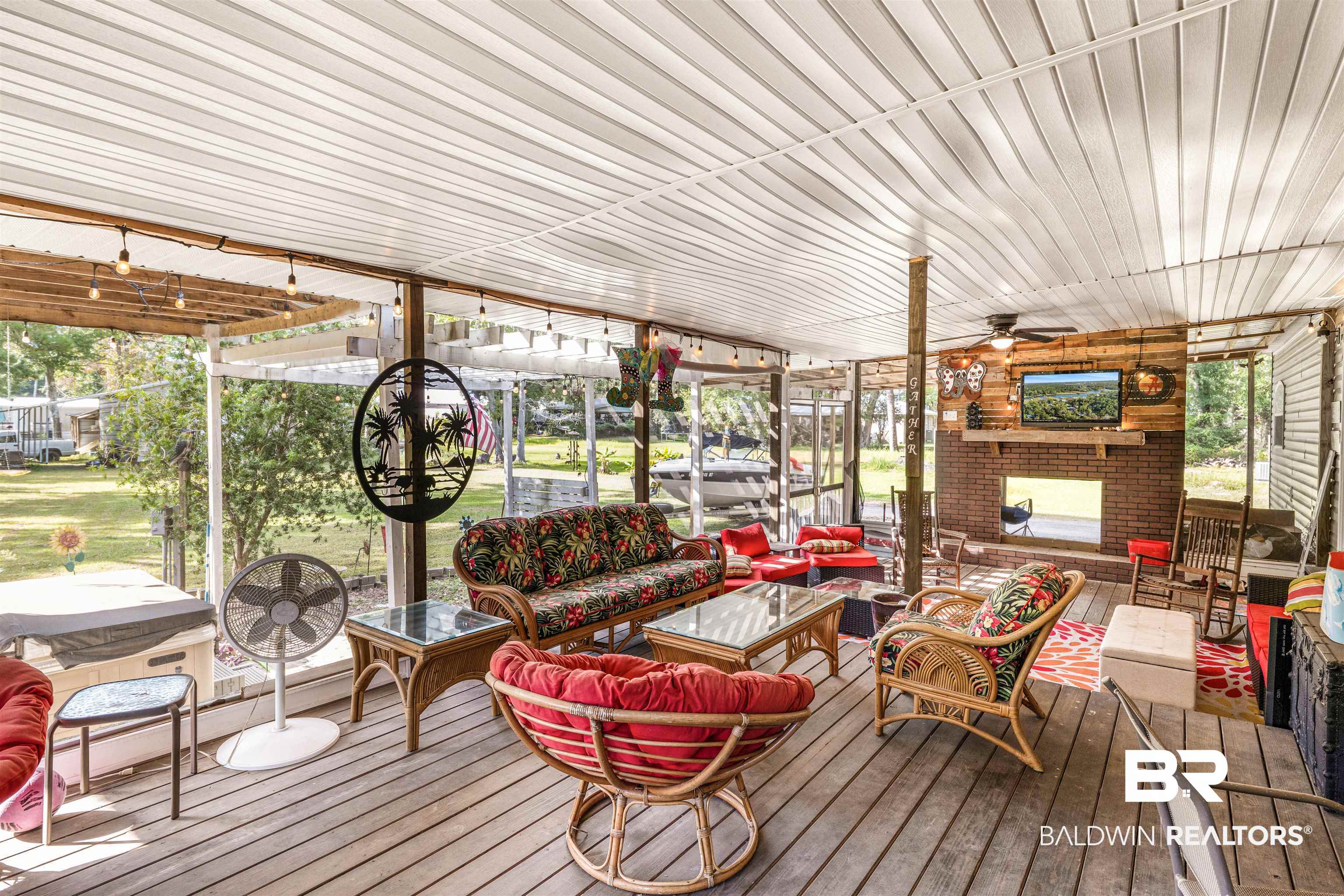 6921 Piney Woods Road Foley, AL 36535 - Photo 28 of 44 Sunroom featuring wood ceiling, a wealth of natural light, and ceiling fan