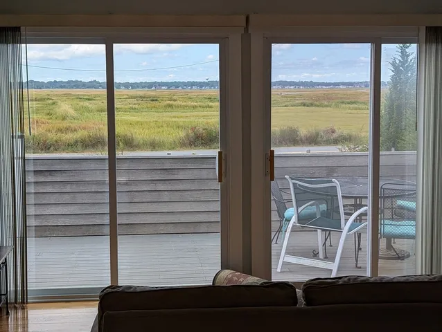 a view of an empty room and floor to ceiling window