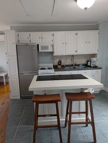 a kitchen with a table chairs and a stove