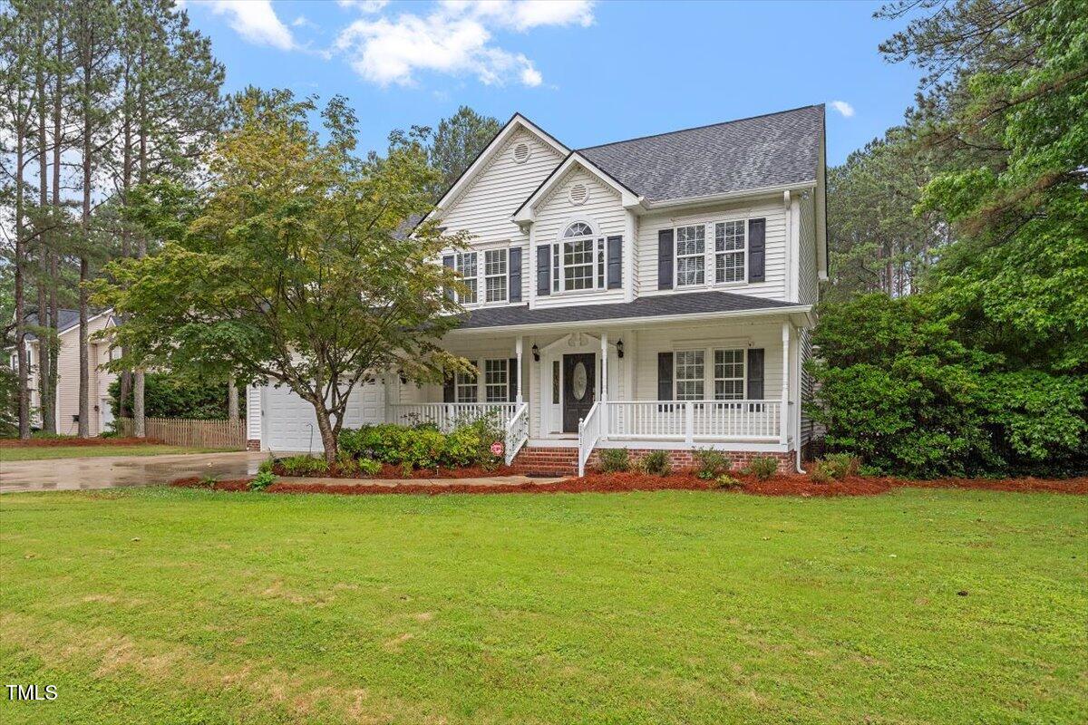1817 Foxbrook Drive Raleigh, NC 27603 - Photo 15 of 61 a front view of a house with garden and porch