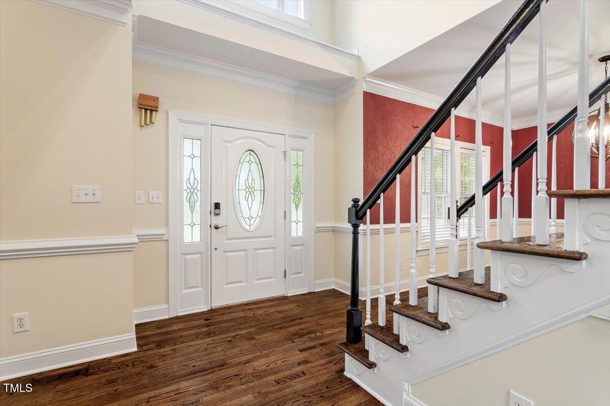 1817 Foxbrook Drive Raleigh, NC 27603 - Photo 18 of 61 a view of entryway and hall with wooden floor
