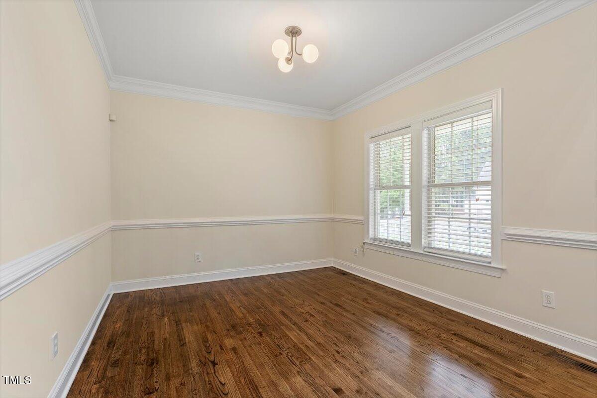 1817 Foxbrook Drive Raleigh, NC 27603 - Photo 21 of 61 wooden floor in an empty room with a window
