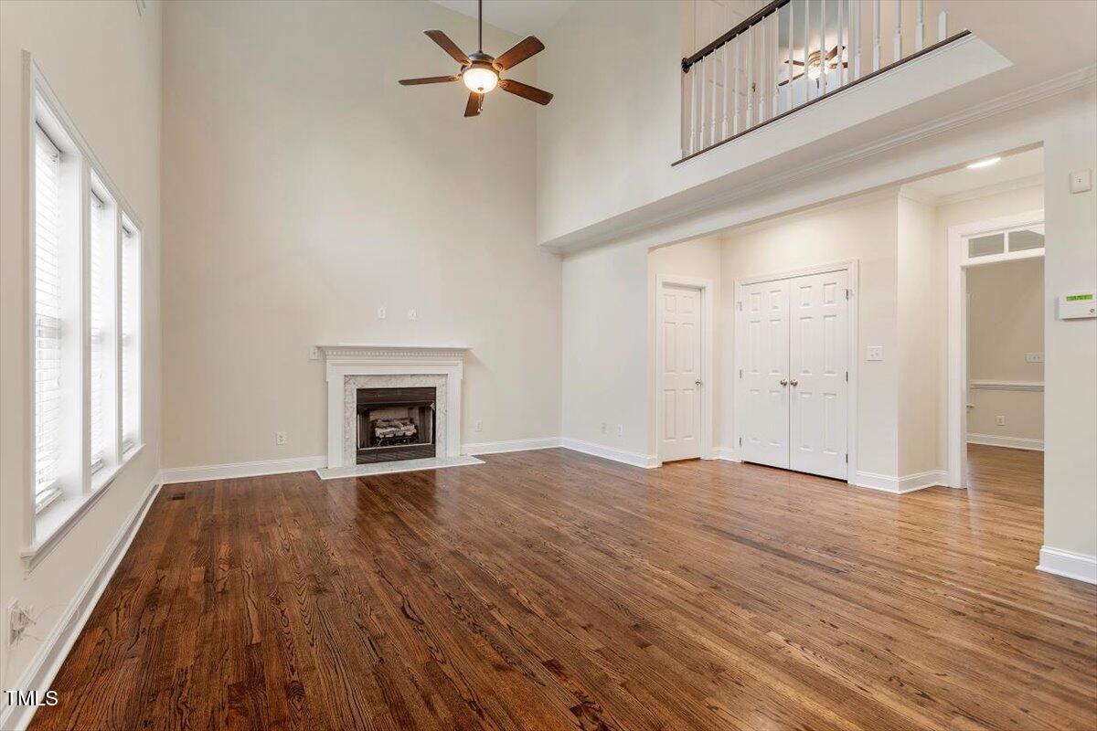 1817 Foxbrook Drive Raleigh, NC 27603 - Photo 23 of 61 a view of an empty room with wooden floor and a window