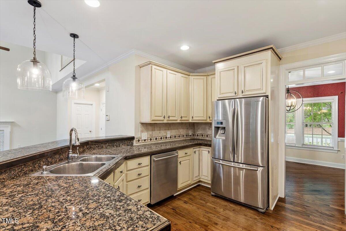 1817 Foxbrook Drive Raleigh, NC 27603 - Photo 28 of 61 a kitchen that has a refrigerator a sink and wooden floor