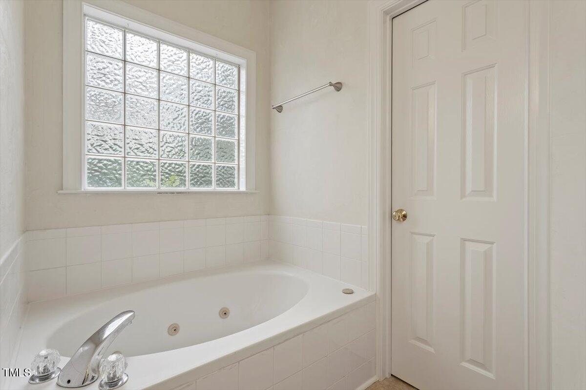 1817 Foxbrook Drive Raleigh, NC 27603 - Photo 35 of 61 a bath tub sitting next to a window