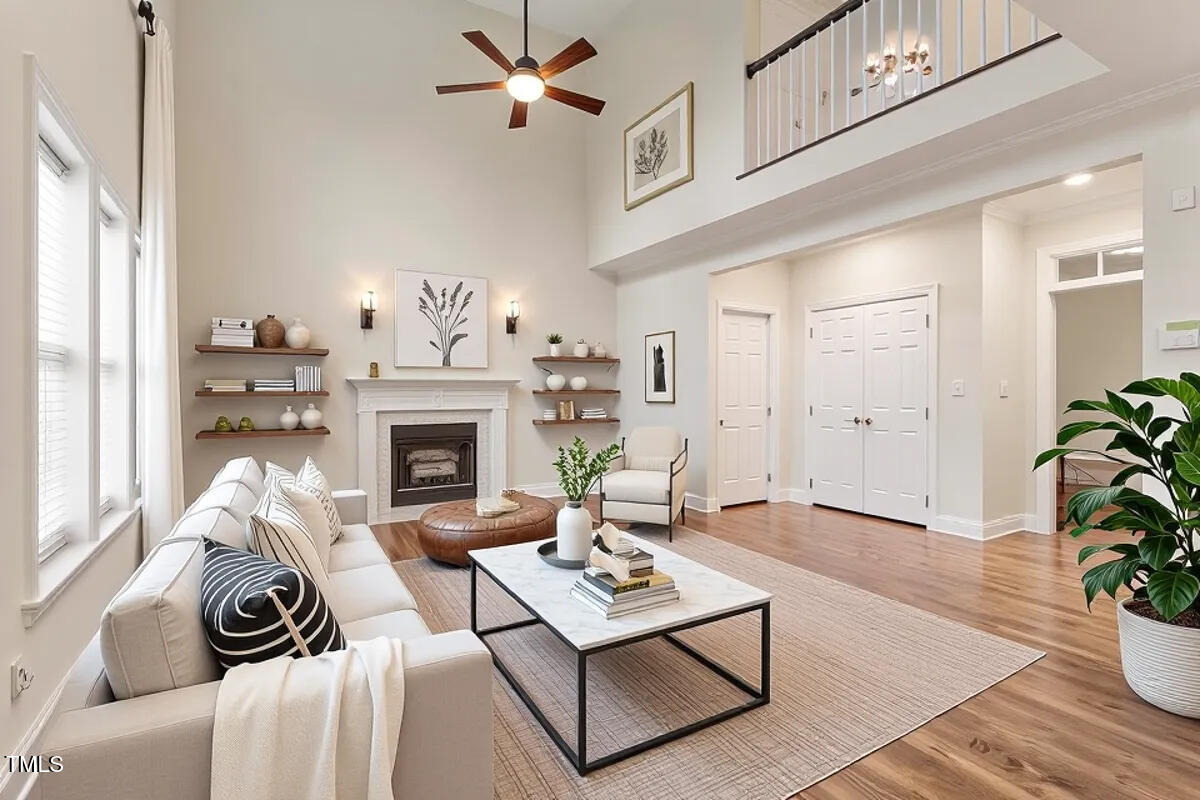 1817 Foxbrook Drive Raleigh, NC 27603 - Photo 4 of 61 a living room with furniture a fireplace and a potted plant