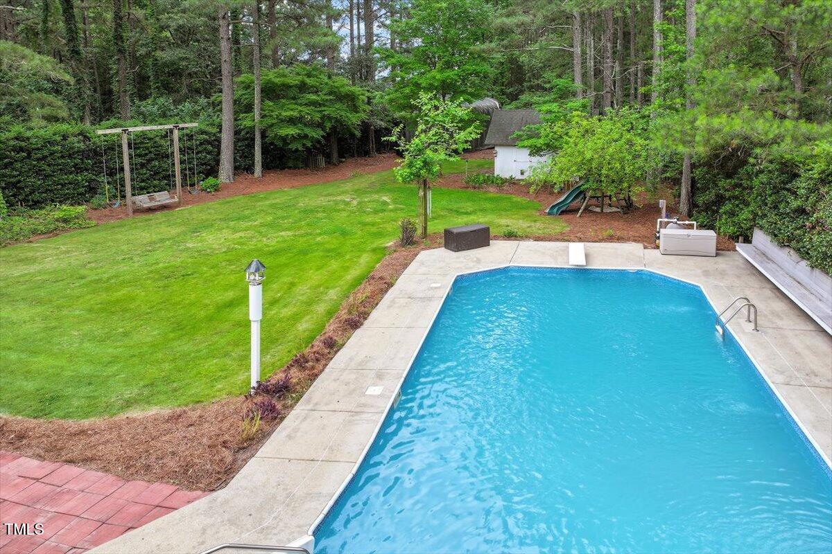 1817 Foxbrook Drive Raleigh, NC 27603 - Photo 57 of 61 a view of yard with swimming pool and green space