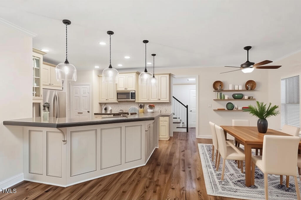 1817 Foxbrook Drive Raleigh, NC 27603 - Photo 5 of 61 a large kitchen with kitchen island white cabinets and stainless steel appliances
