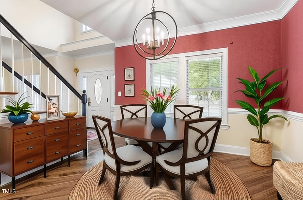 1817 Foxbrook Drive Raleigh, NC 27603 - Photo 6 of 61 a dining room with furniture potted plants and wooden floor