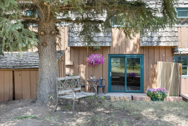 a front view of a house with wooden floor and bench