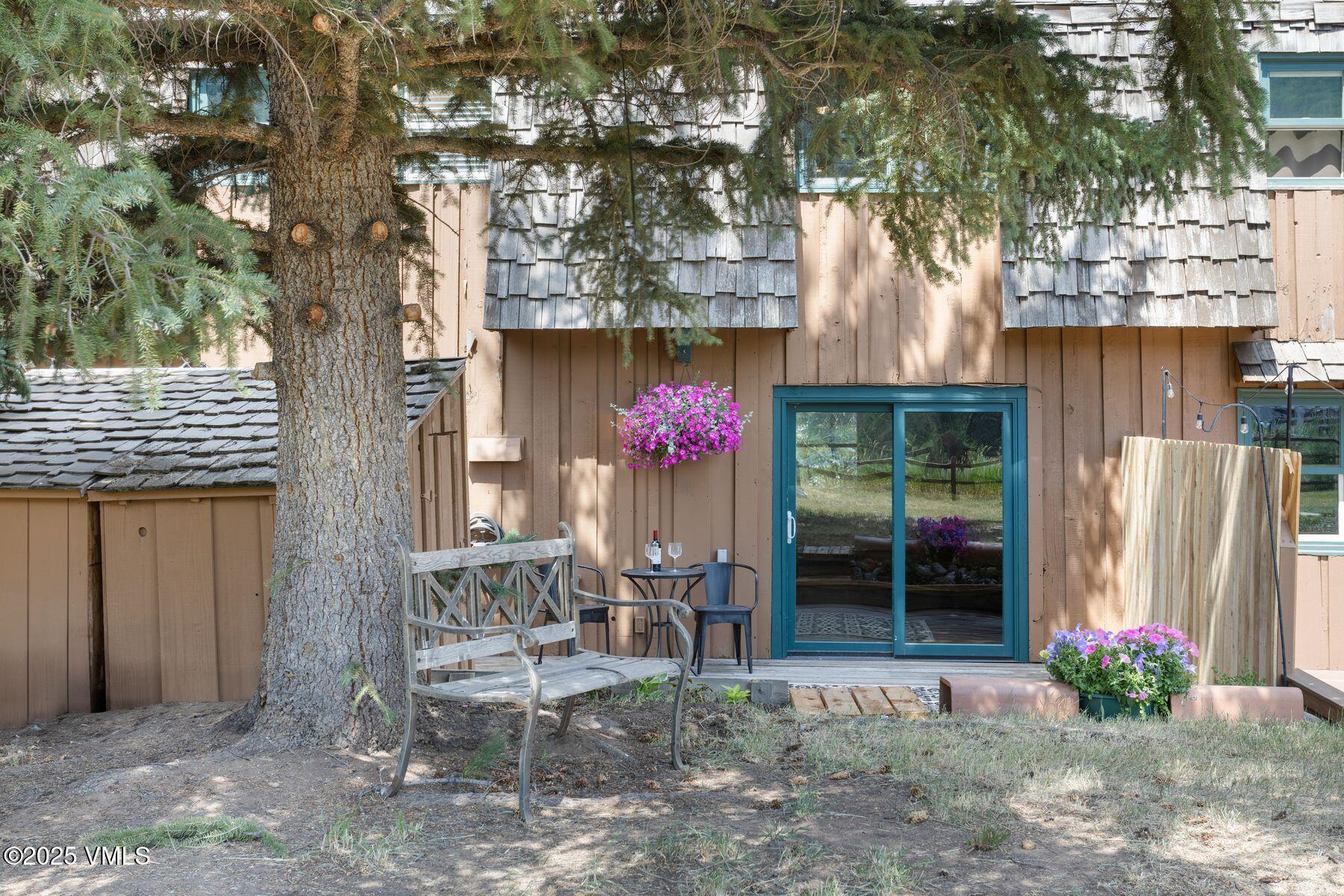 2456 Chamonix Lane, Unit B3 Vail, CO 81657 - Photo 15 of 29 a house with a table and chairs in front of it
