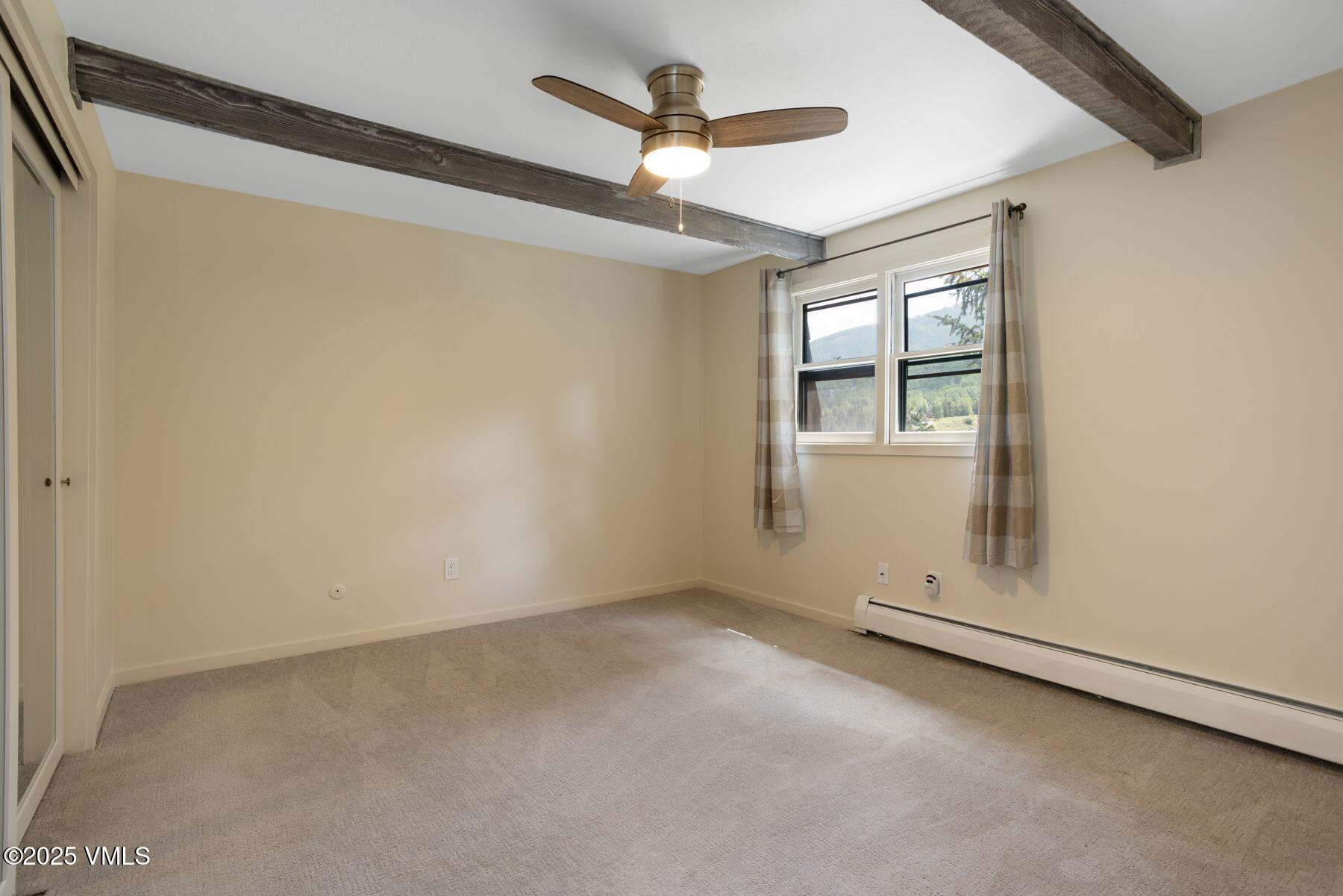 2456 Chamonix Lane, Unit B3 Vail, CO 81657 - Photo 21 of 29 an empty room with windows and ceiling fan