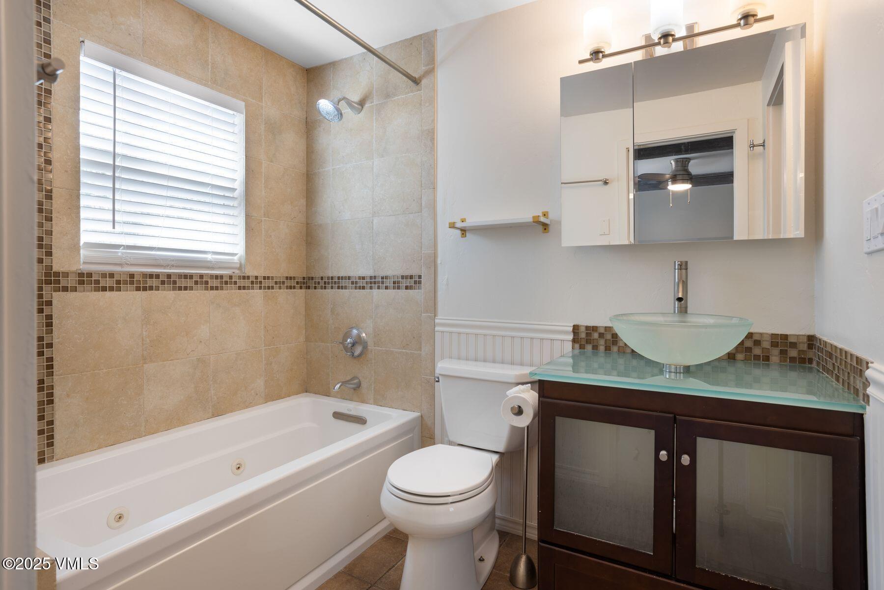 2456 Chamonix Lane, Unit B3 Vail, CO 81657 - Photo 23 of 29 a bathroom with a granite countertop sink toilet and shower