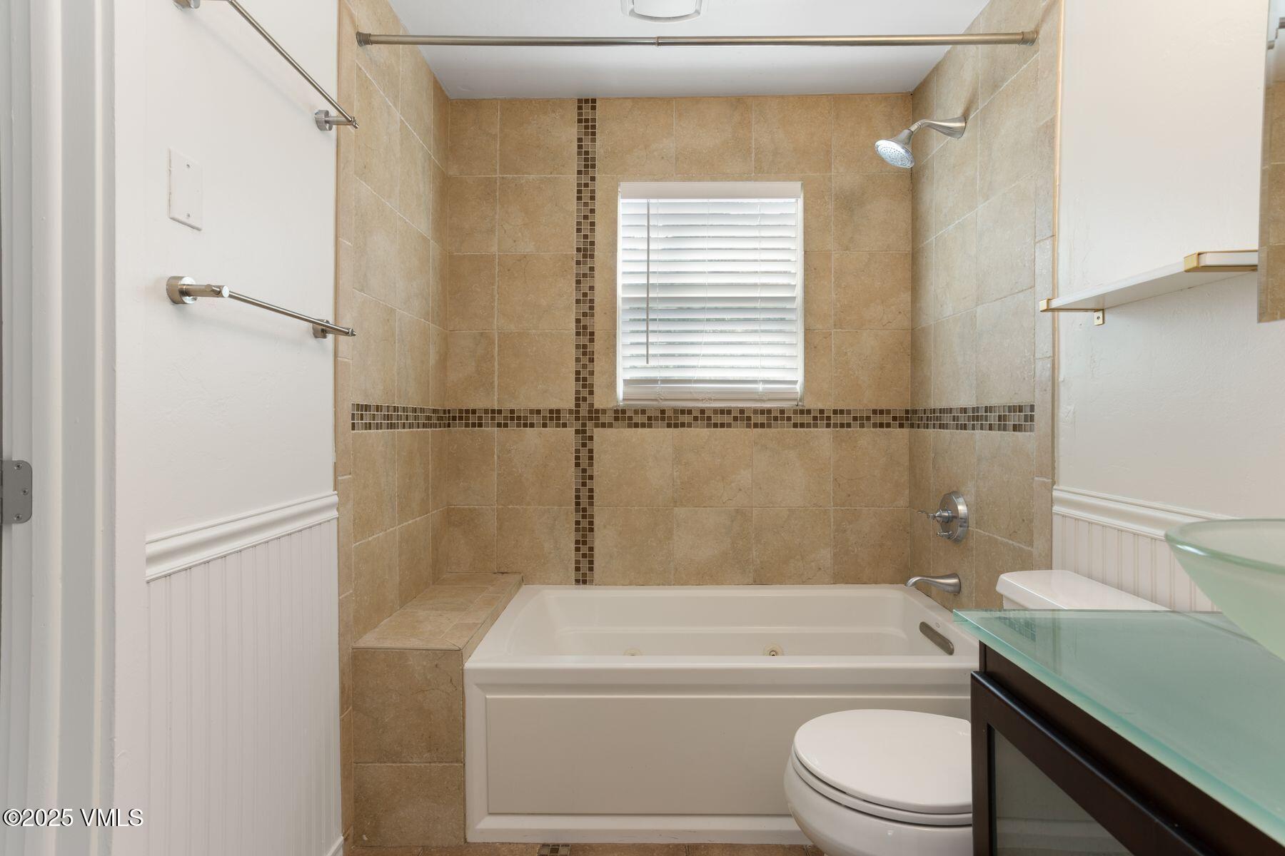 2456 Chamonix Lane, Unit B3 Vail, CO 81657 - Photo 24 of 29 a bathroom with a granite countertop toilet sink and bathtub