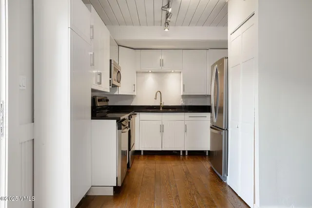a view of a kitchen with electric appliances