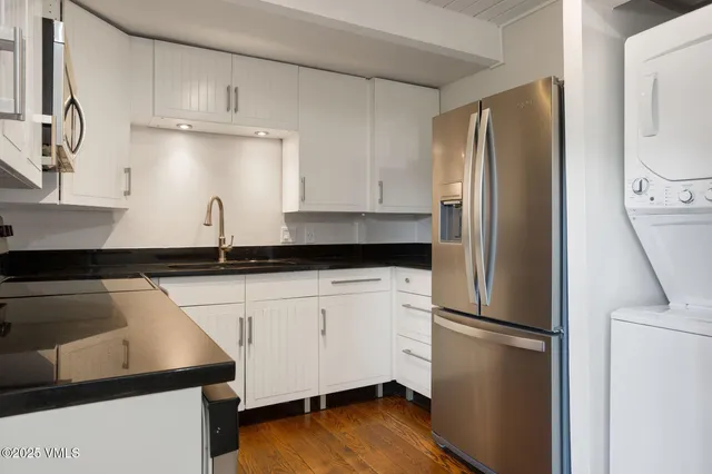 a kitchen with stainless steel appliances a refrigerator sink and cabinets