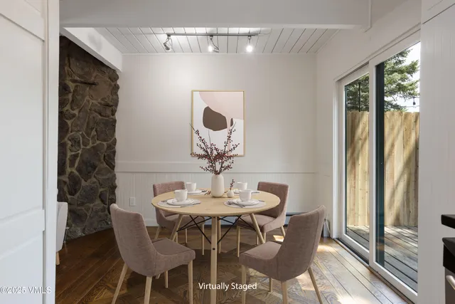 a view of a dining room with furniture and wooden floor