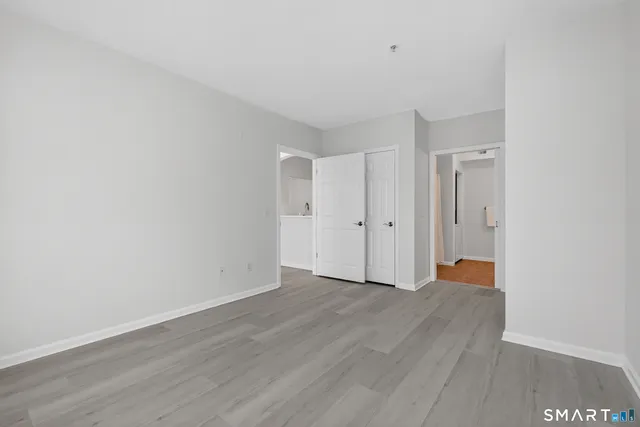 a view of an empty room with wooden floor