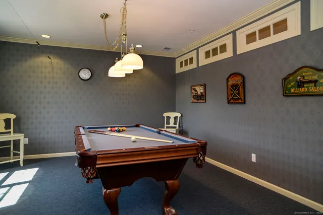 a room with pool table and windows