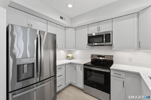 a kitchen with a refrigerator stove and microwave